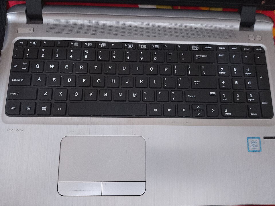 Laptop keyboard with a compact function row, arrow keys and integrated numeric keypad.